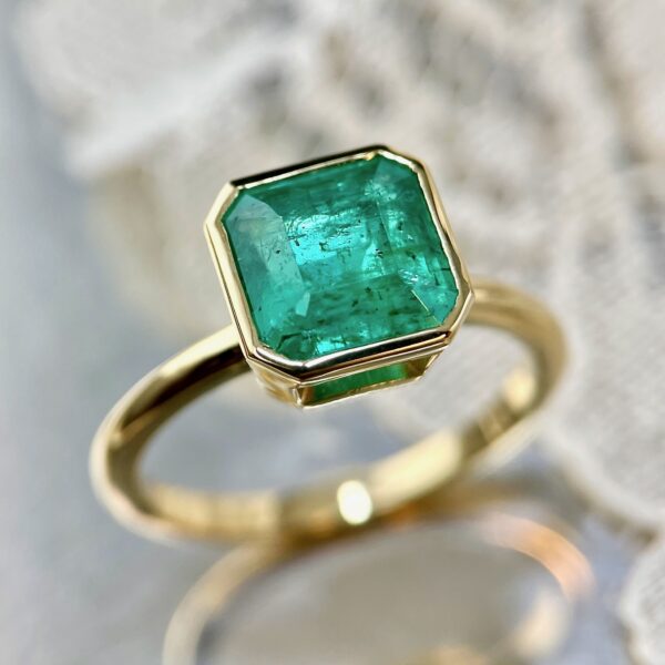 Bezel set emerald ring
