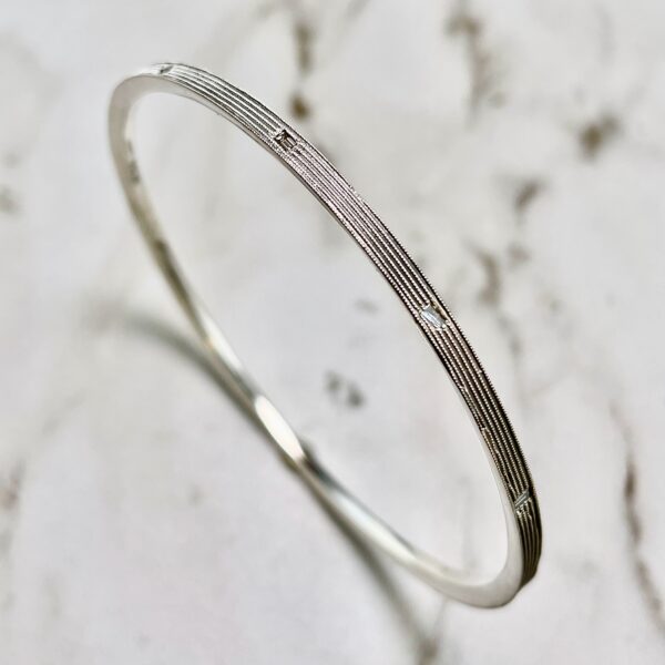 Silver bangle bracelet with diamonds