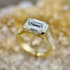 Emerald cut diamond with pave